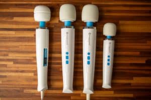Left to right - Hitachi Magic Wand Original, Rechargeable, Plus, and Mini side by side on a table